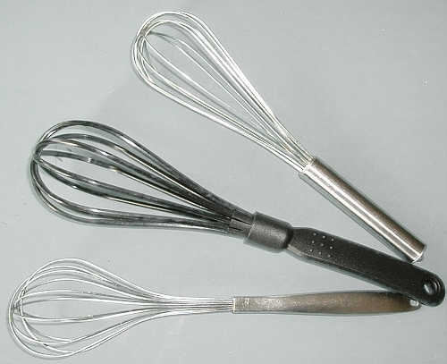 A metal kitchen whisk